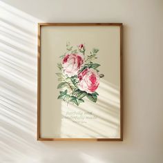 a framed print with pink roses on it