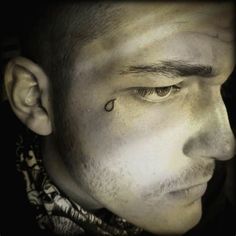 a close up of a person with a scar around his neck and nose piercings