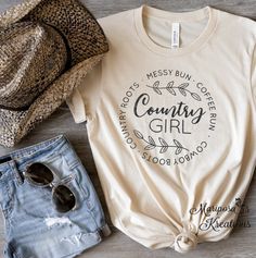 Country Girl T-shirt-Shirt-Popular-Birthday Gift-Rodeo-Country Shirt-Cowboy Boots-Messy Bun-Country Roots-Coffee Run Bella Canvas T-shirt is so soft, breathable, comfy and it moves with you.  100% Airlume combed and ring spun cotton.   💥 Please see size chart prior to ordering.  💖 Listing is for one garment item.  💥CARE INSTRUCTIONS  -Wash inside out  -Machine wash cold  -Do not bleach -Do not dry clean  -Do not iron directly onto the design  -Tumble dry low  ❤️ Thank you for visiting! 🦋 Fol Country Style Cotton Tops With Letter Print, Country T Shirts, Country Girl Gifts, Country Girl Shirts, Sublimation Ideas, Country Music Shirts, Rodeo Shirts, Everyday Quotes, Distressed Shirt