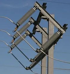 an electric pole with multiple wires attached to it and blue sky in the back ground