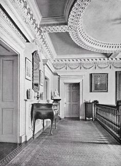 an old black and white photo of a room with a table in the middle of it