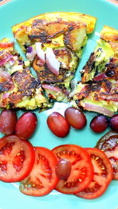 a plate topped with slices of pizza and sliced tomatoes next to olives on the side