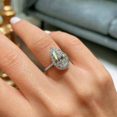 a woman's hand with a diamond ring on it