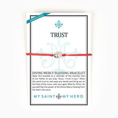 a red string bracelet with the words trust and an image of a cross on it