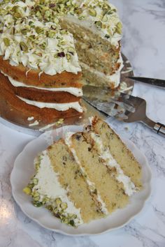 a slice of cake on a plate next to the rest of the cake and knife