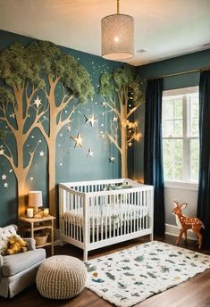 a baby's room decorated in blue and white with trees painted on the wall