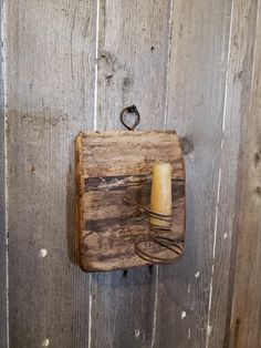 a wooden wall with a light switch on it and a wire attached to the wood