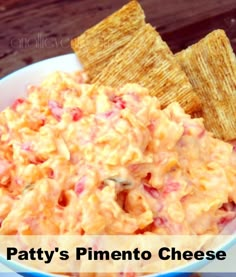 a bowl filled with cheese and crackers on top of a table