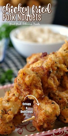 chicken fried pork nuggets on a red and white plate