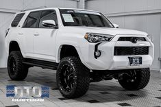 a white toyota 4runner is parked in a garage