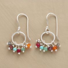 two pairs of silver hoop earrings with multicolored beads and dangling earwires