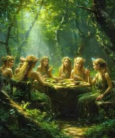 a group of women sitting around a table in the woods