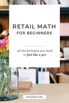 a sign that says retail math 101 with flowers in a vase on the table next to it