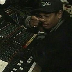 a man sitting in front of a mixing desk