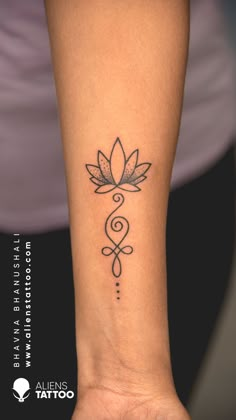 a woman's arm with a tattoo on it that has a flower in the middle