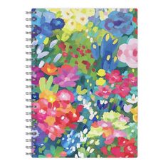 a spiral notebook with colorful flowers on the front and bottom, featuring an image of many different