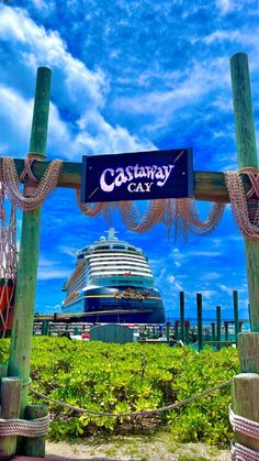 a sign that is in front of a cruise ship and some plants on the ground