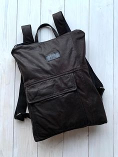 "One of a kind brown up-cycled leather backpack with pockets.  Backpack is light in weight and comfortable to use. Has lining and two pockets inside also one extra zipped pocket on the back side in the exterior. Leather backpack fits 15\" laptop.  FEATURES | One zipped and one open pocket inside | Lining (mostly natural material) | Zipped pocket on the back backpack side Dimensions - 42 H x 32 W x 6 D // 16.5\" x 12.6\" x 2.4\" You can choose backpack plus up-cycled leather purse. Pouch is perfe Functional Leather Backpack With Waxed Finish For Daily Use, Brown Leather Backpack With Zipper Pocket For School, Brown Leather Backpack With Pockets For Outdoor, Functional Leather Backpack With Pockets For Everyday, Brown Leather Backpack For Outdoor With Zipper Pocket, Brown Leather Backpack With Zipper Pocket For Outdoor, Brown Backpack With Zipper Pocket For Everyday Use, Brown Leather Backpack With Zipper For Outdoor, Everyday Waxed Canvas Backpack With Pockets