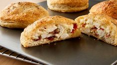 there are some biscuits that have been cut in half and placed on a baking sheet