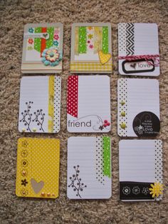 six small notebooks are laid out on the floor with different designs and colors,