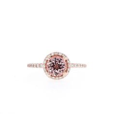 Beatrice Pink Sapphire Round Cut Ring For Wedding, Pink Round Halo Ring, Blush Diamond Jewelry With Center Stone, Pink Halo Ring With Round Setting, Pink Sapphire Round Cut Ring, Classic Round Halo Ring With Accent Stones, Timeless Round Halo Ring With Halo Setting, Rose Gold Halo Setting Round Wedding Ring, Rose Gold Halo Ring With Round Cut