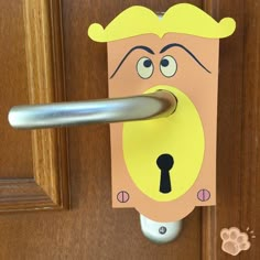 a door handle with a paper cutout of a man's face on it