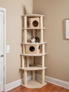 a cat sitting on top of a scratching tower