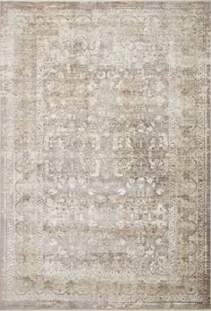 an antique style rug in beige and grey tones