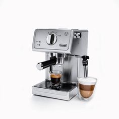 the espresso machine is next to a cup of coffee