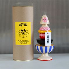 a small toy sitting on top of a table next to a can