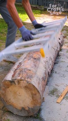 a man is cutting down a large log