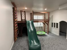 a green slide in the middle of a room