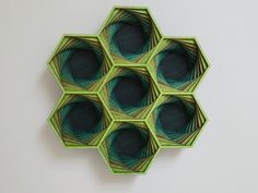 four green hexagonals are arranged on the wall