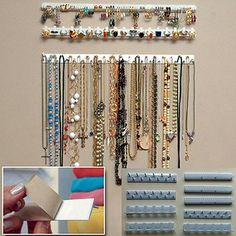 a wall mounted jewelry rack with lots of necklaces