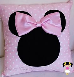 a minnie mouse pillow with a pink bow on it