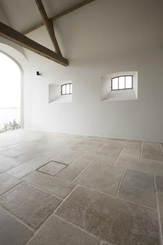 an empty room with two windows in it