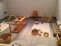 a room filled with lots of furniture and toys on top of a hard wood floor