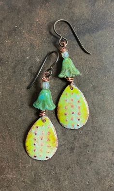 Unique and fun enamel on copper earrings with punched dots design on blue/green background. A fun floral glass bead is added which gives a boho look. Enamel is then applied to both sides. Enamel is powdered glass that is fused to a base metal, in my case I use copper. I fire torch all my jewelry at a very high temperature of around 1500 F.  The beautiful shades of white and blue some opaque and transparent transform those earrings.  The back of the earring is also enameled with clear glass to reveal the beauty of the copper. Total length with the ear wire is just a little above 1 1/2  inches Thank you for visiting my shop and do not hesitate to contact me if you have any questions. These items are wrapped carefully  and placed in a padded envelop. These earrings are ready to ship. Please n Blue Green Background, Fire Torch, Art Jewelry Earrings, Copper Gifts, Mojave Desert, Dots Design, Enamel Earrings, Green Enamel, Earrings Black