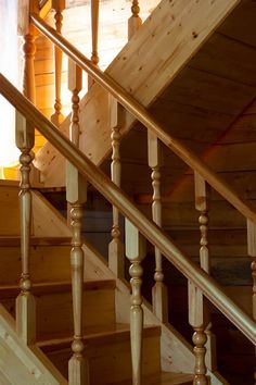 a wooden staircase with handrails and wood balconies