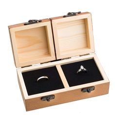 an open wooden box with two rings inside