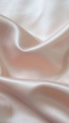 a close up view of a white satin fabric