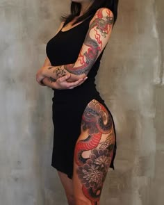 a woman with tattoos on her arm and leg