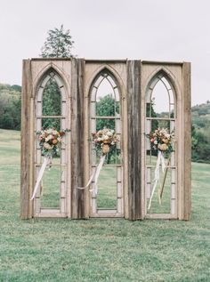 an instagram page with two wooden doors and flowers on the front, one door is open