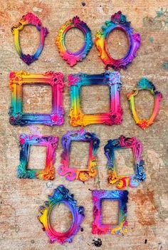 colorful frames are arranged in the shape of letters and numbers on a wooden surface with paint splattered over them