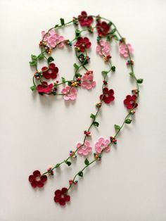 a necklace made out of flowers and beads