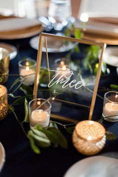 the table is set with candles and place settings for dinner guests to enjoy their meal