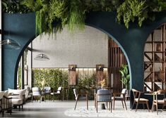 the interior of a restaurant with blue walls and greenery