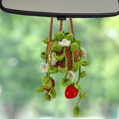 a crocheted decoration hanging from a car's side mirror