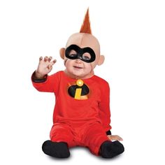 a baby dressed in a costume sitting on the ground with his hands up and eyes closed