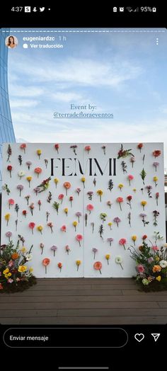 an image of flowers on a wall with the words eeemi written in spanish